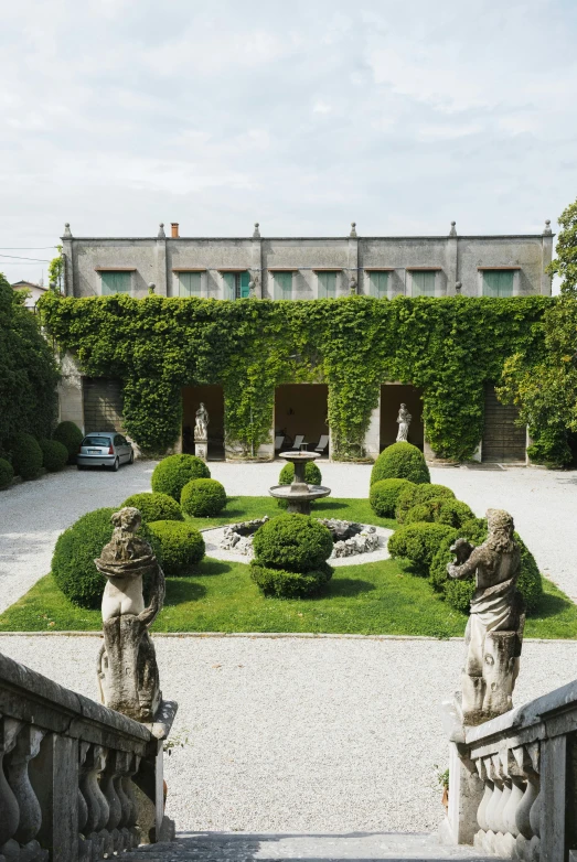 a couple of statues sitting on top of a set of stairs, lush garden in the background, david palladini, overview