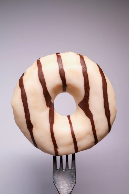 a close up of a doughnut on a fork, inspired by Joris van der Haagen, chocolate river, soft frontal light, bold black lines, ivory carved ruff