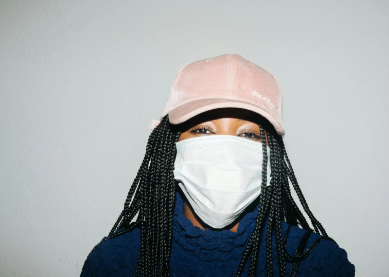 a person wearing a mask and a hat, by Dulah Marie Evans, trending on pexels, cardi b, white and pink cloth, virus, sza