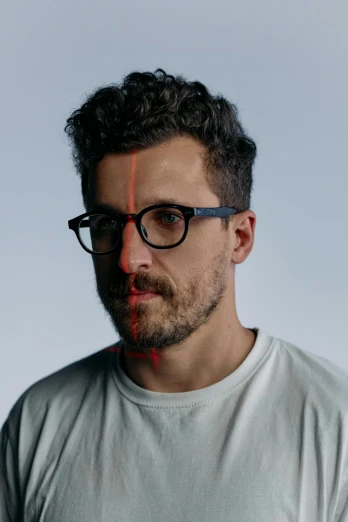 a man wearing glasses and a white t - shirt, an album cover, inspired by Thomas Wijck, refik anadol, shaven stubble, andy samberg, portrait image
