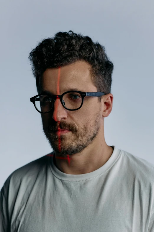 a man wearing glasses and a white t - shirt, an album cover, inspired by Thomas Wijck, refik anadol, shaven stubble, andy samberg, portrait image