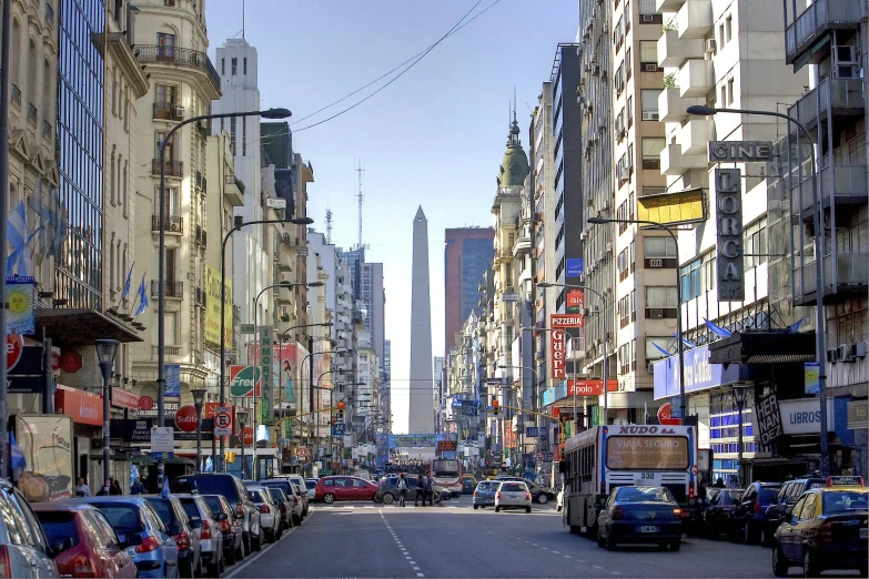 a city street filled with lots of traffic and tall buildings, by Luis Molinari, obelisk, argentina, crisp image, square