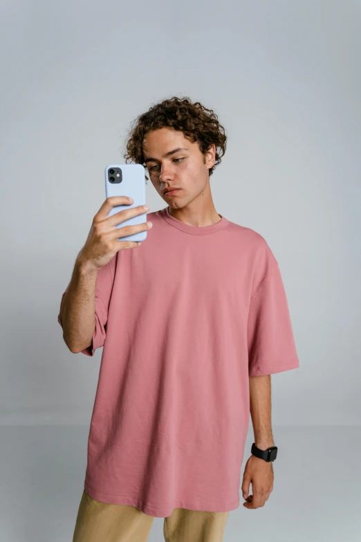 a man taking a selfie with his cell phone, trending on pexels, pink clothes, muted arm colors, teenage boy, cut out