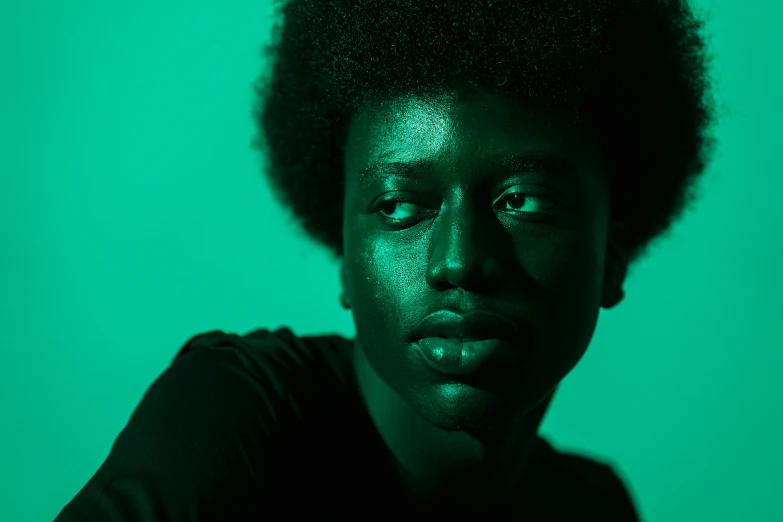 a close up of a person with a green background, by Thomas Bock, pexels contest winner, afrofuturism, duotone, dark black skin tone, by emmanuel lubezki, portrait androgynous girl