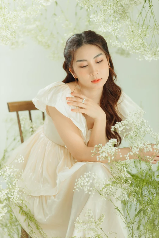 a woman in a white dress sitting on a chair, inspired by Kim Du-ryang, pexels contest winner, rococo, soft style, airy colors, close up portrait photo, background image