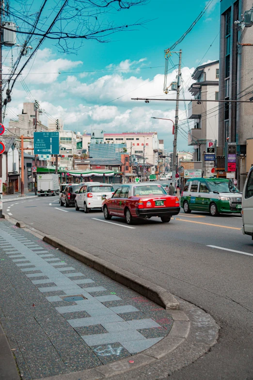 a street filled with lots of traffic next to tall buildings, shin hanga, small town surrounding, cars, 🚿🗝📝, bright sunny day