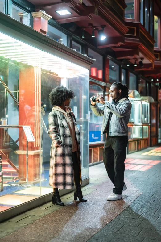 a man taking a picture of a woman in a store window, trending on pexels, happening, ashteroth, movie still 8 k, seoul, street wears