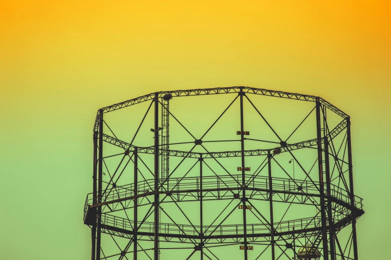 a large metal structure sitting in the middle of a field, inspired by Elsa Bleda, pexels contest winner, bauhaus, green and yellow tones, watertank, detailed silhouette, multicoloured