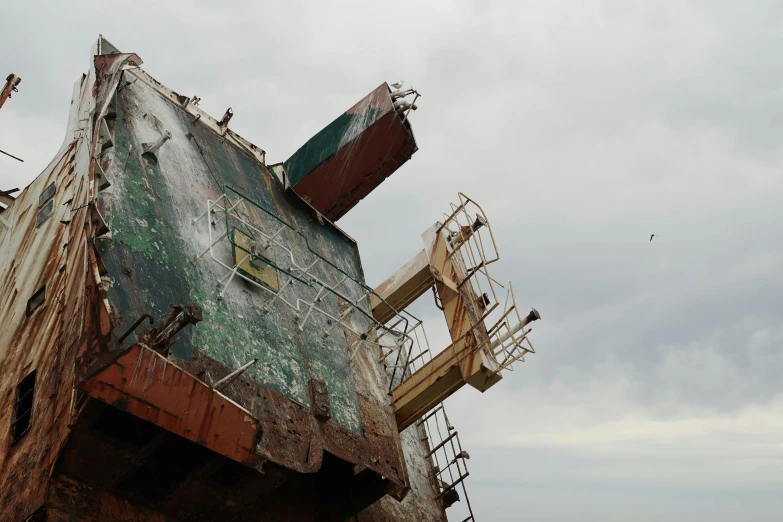 a rusty ship sitting on top of a sandy beach, unsplash, auto-destructive art, view from below, big graphic seiner ship, 2 0 0 0's photo, demolition