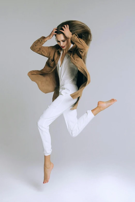 a woman that is jumping in the air, by Daniel Taylor, light brown trenchcoat, sleek white, wearing human air force jumpsuit, covered!