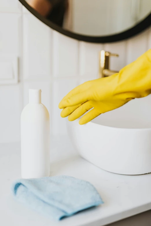 a person in yellow rubber gloves cleaning a bathroom sink, unsplash, plasticien, on a pale background, bottle, thumbnail, splash image