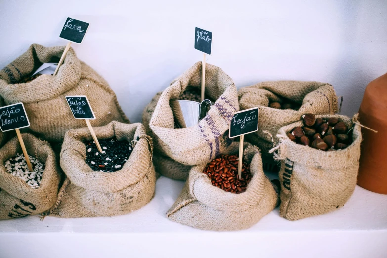 a bunch of bags filled with different types of nuts, by Emma Andijewska, trending on unsplash, process art, coffee shop, burlap, chocolate, 15081959 21121991 01012000 4k