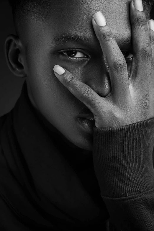 a black and white photo of a man with his hands on his face, by Cosmo Alexander, pexels contest winner, black teenage boy, sleek hands, godwin akpan, with a pointed chin