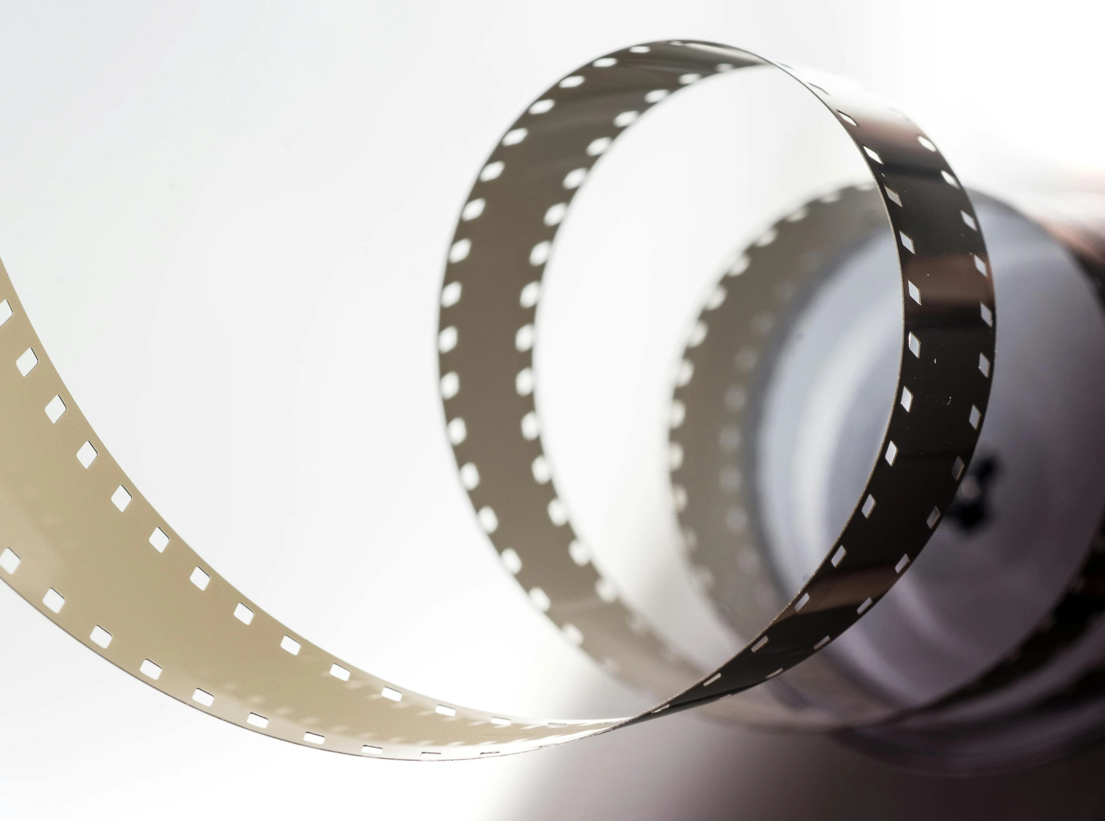 a roll of film sitting on top of a table, a picture, award-winning cinema, close-up photograph, thin film, movies