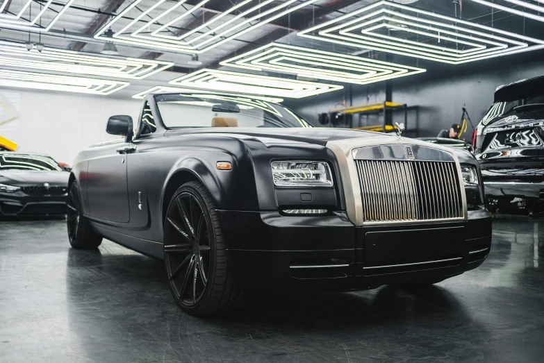 a black rolls royce parked in a garage, renaissance, featuring rhodium wires, production ready, huhd, square