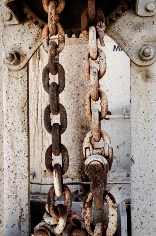 a close up of a chain attached to a fire hydrant, by Anton Möller, renaissance, rusted panels, white steel, doorway, close-up photograph