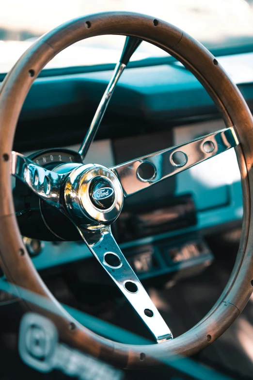 a close up of a steering wheel on a car, mustang, multiple stories, feature, single image