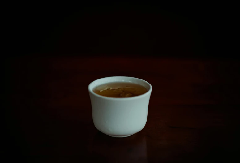 a close up of a cup of coffee on a table, daoshu, traditional medium, unshaded, single