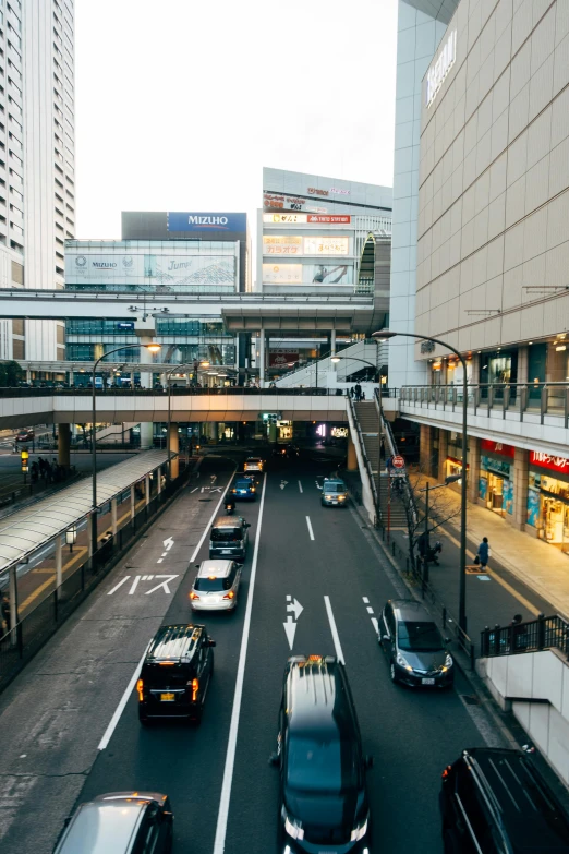 a street filled with lots of traffic next to tall buildings, unsplash, sōsaku hanga, terminal, exterior shot, square, multi - level