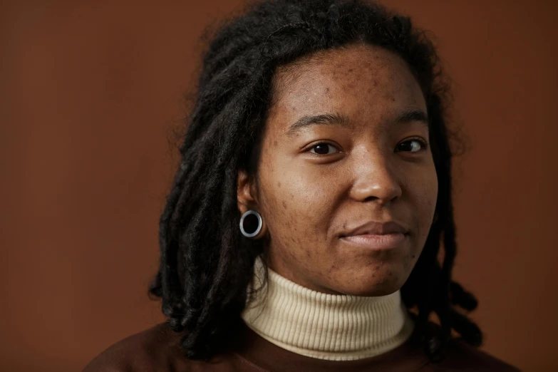 a close up of a person with dreadlocks, a character portrait, by Carey Morris, trending on pexels, wearing turtleneck, ( brown skin ), magdalena andersson, cinnamon skin color