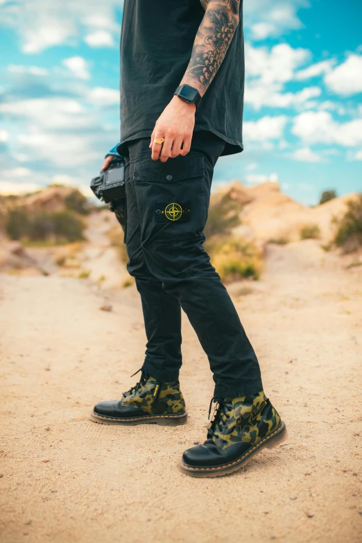 a man standing in the middle of a dirt road, inspired by national geographic, unsplash, photorealism, wearing cargo pants, techwear, patterned, profile pic