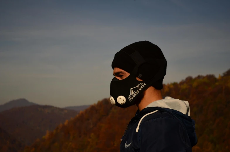 a person wearing a face mask with mountains in the background, inspired by Ernő Bánk, instagram, winter soldier mask, during autumn, sport, profile picture 1024px