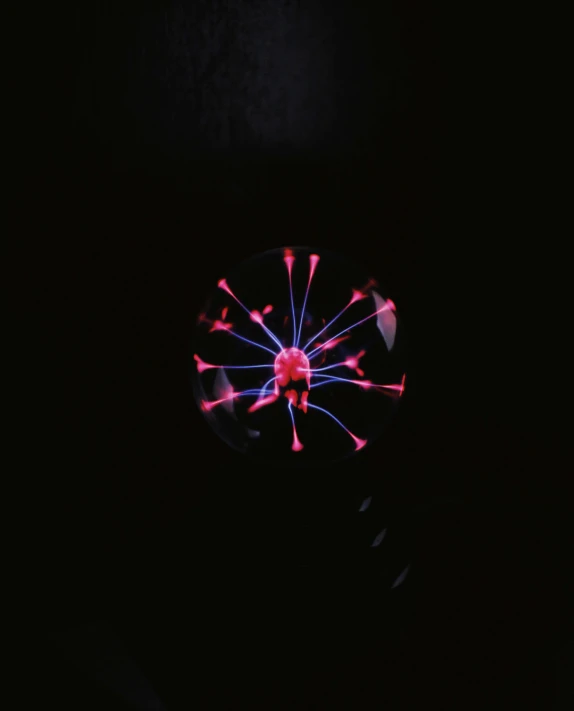 a close up of a light bulb in the dark, a hologram, inspired by Bruce Munro, unsplash, kinetic art, seven pointed pink star, made of ferrofluid, top-down view, neuron
