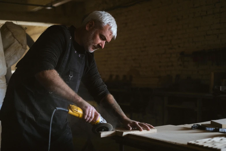 a man is working on a piece of wood, a portrait, pexels contest winner, “ iron bark, 15081959 21121991 01012000 4k, dust around, smooth panelling