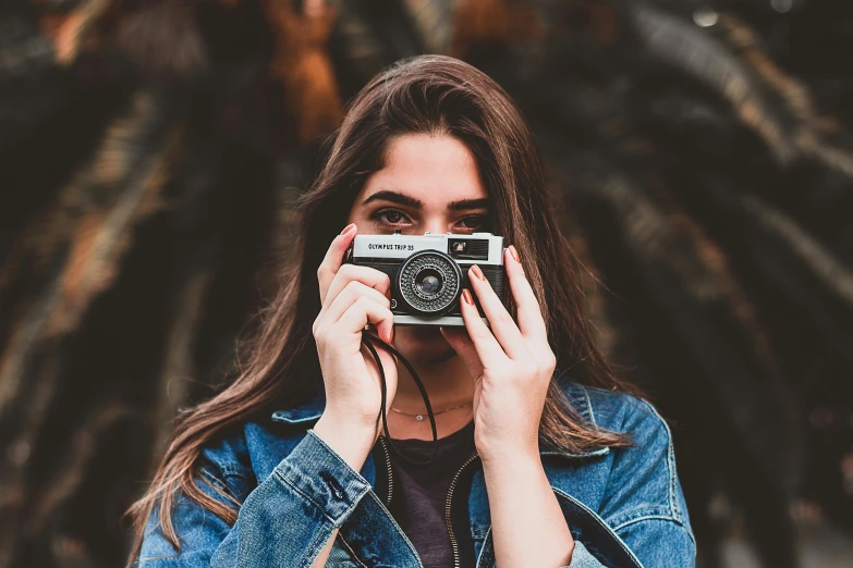 a woman taking a picture with a camera, a picture, inspired by Elsa Bleda, unsplash contest winner, smirking at the camera, hd wallpaper, instagram model, 8 0 s camera