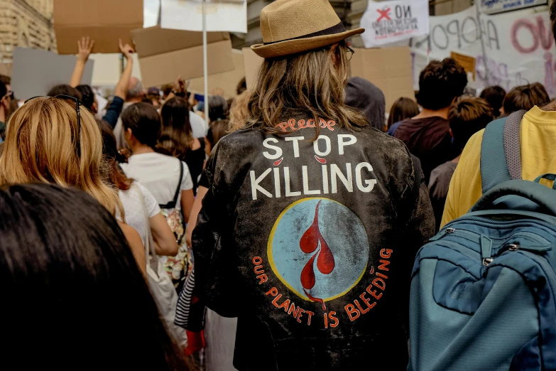 a group of people standing next to each other, trending on unsplash, sots art, blood stains on shirt, placards, environmental shot, wearing a fancy jacket