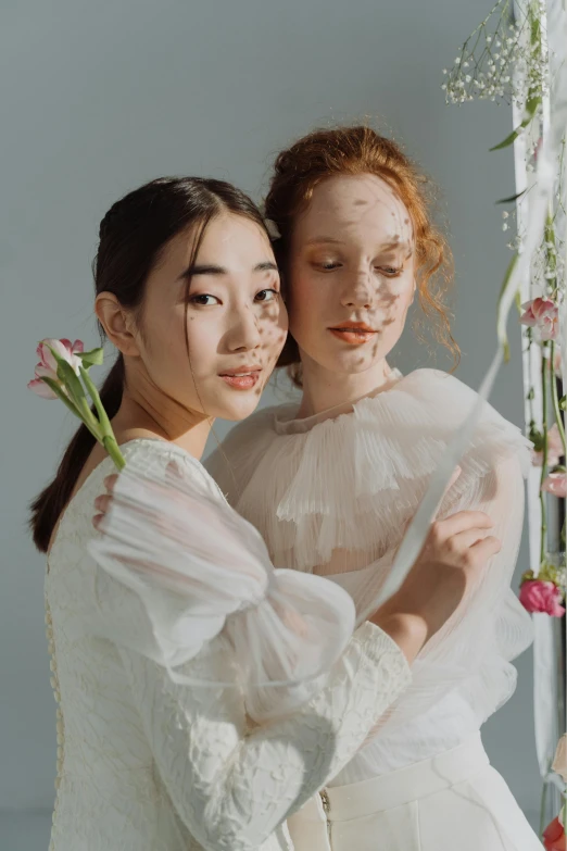 a couple of women standing next to each other, inspired by Cecil Beaton, trending on pexels, rococo, freckled pale skin, young asian woman, wedding, ignant