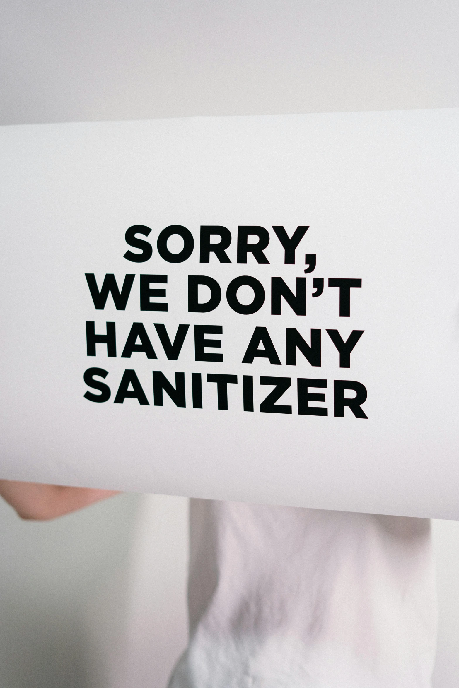 a person holding a sign that says sorry we don't have any sanitizer, a poster, by Ben Zoeller, pexels, on white paper, profile picture, alvin schwartz, fresh from the printer