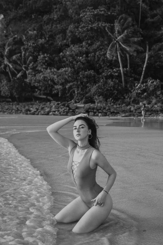 a black and white photo of a woman in a bathing suit on the beach, a black and white photo, pexels contest winner, :: madison beer, lush surroundings, mai anh tran, elizabeth taylor