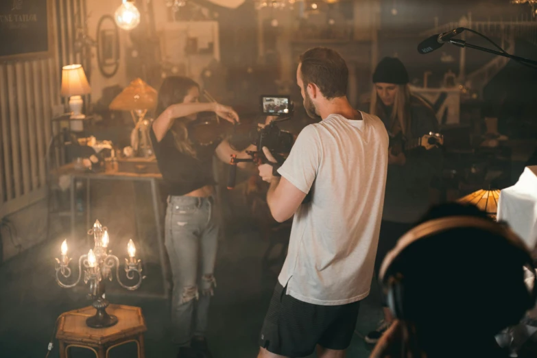 a man that is standing in front of a camera, happening, brandon woelfel, charli bowater and artgeem, worksafe. cinematic, behind the scenes photo