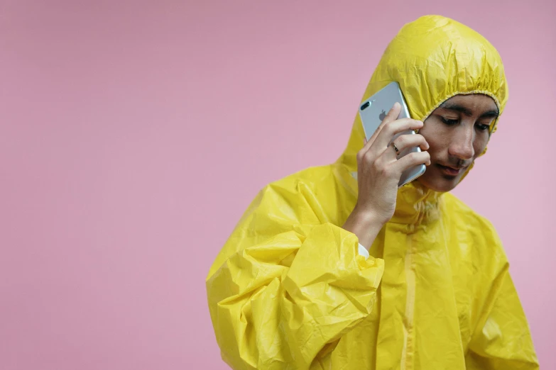 a woman in a yellow rain suit talking on a cell phone, trending on pexels, hyperrealism, karim rashid, devastated, asian man, smartphone photo