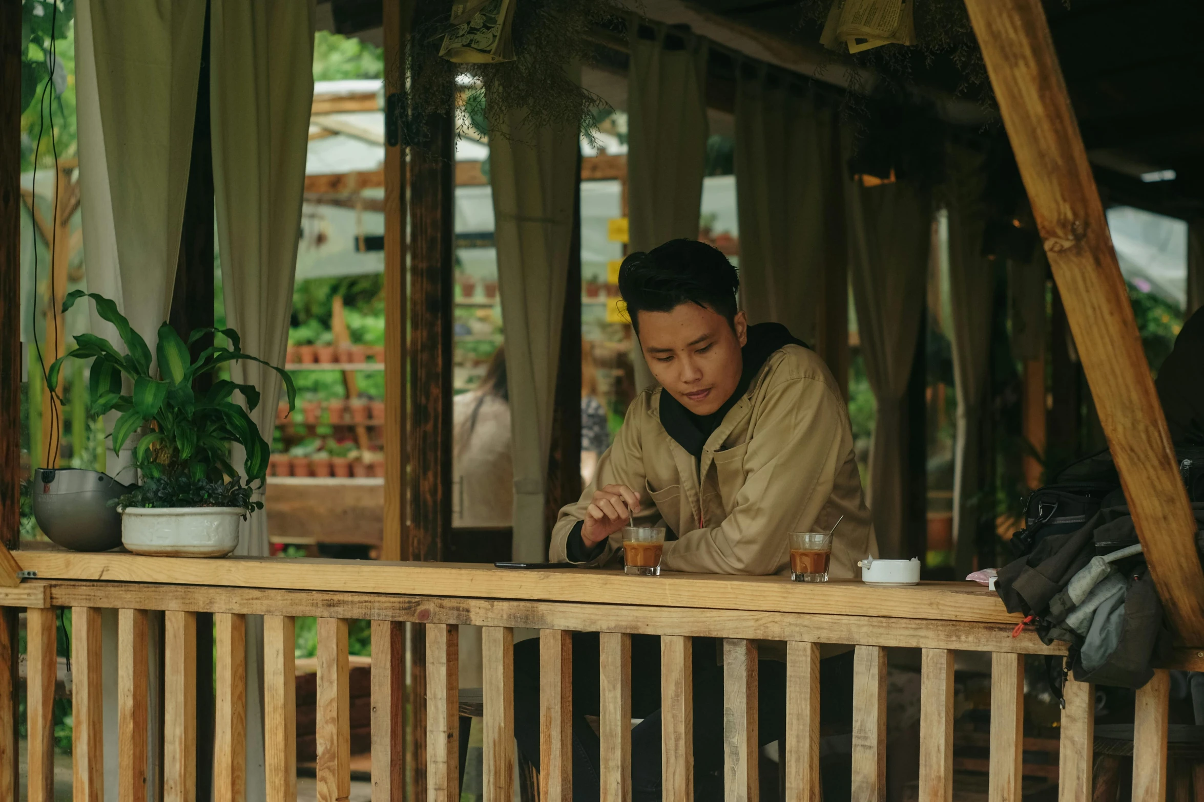 a man that is sitting at a table, pexels contest winner, song nan li, at the terrace, slight overcast, brown