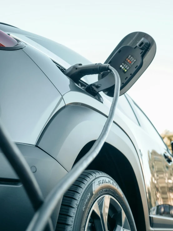 an electric car plugged into a charging station, happening, thumbnail, 10k, 7, black