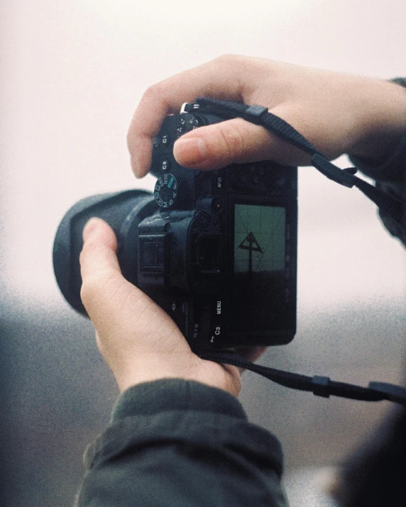 a person taking a picture with a camera, facing away from the camera, non-binary, photograph ”, photography )