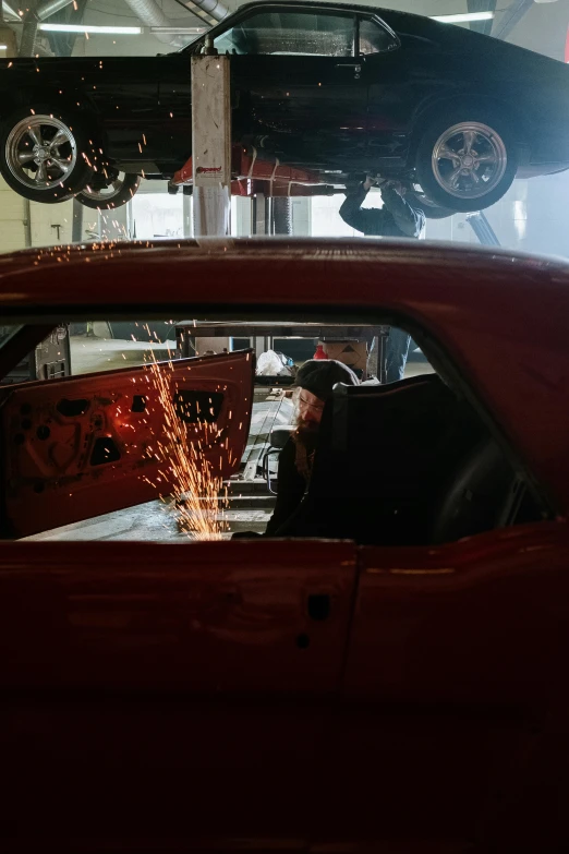 a man working on a car in a garage, a picture, by Dan Frazier, pexels contest winner, made of steel, red car, 15081959 21121991 01012000 4k, high-body detail