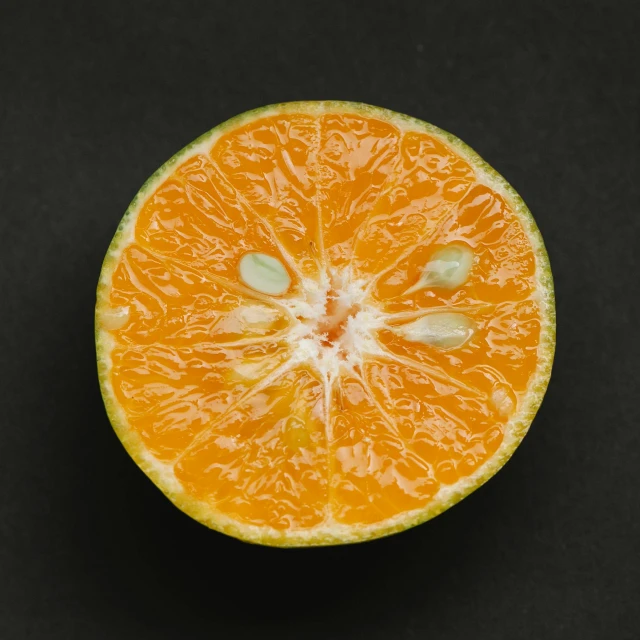 an orange cut in half on a black surface, by Jan Rustem, pexels contest winner, bright green dark orange, hyperdetailed!, 🍸🍋, orange grey white