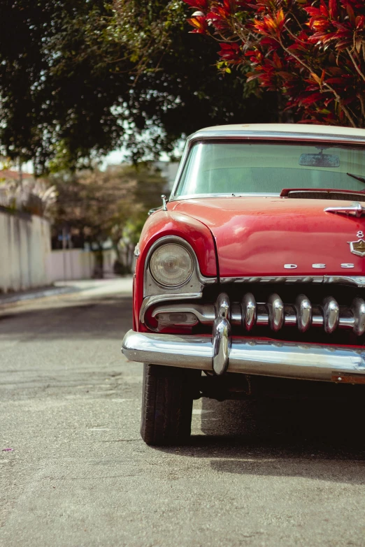 a red classic car parked on the side of the road, pexels contest winner, photorealism, square, 1954, elaborate details, nostalgic 8k