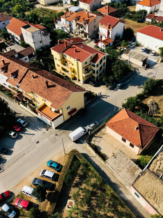 a bird's eye view of a small town, pexels contest winner, happening, photo of džesika devic, in a suburb, tiled roofs, street corner