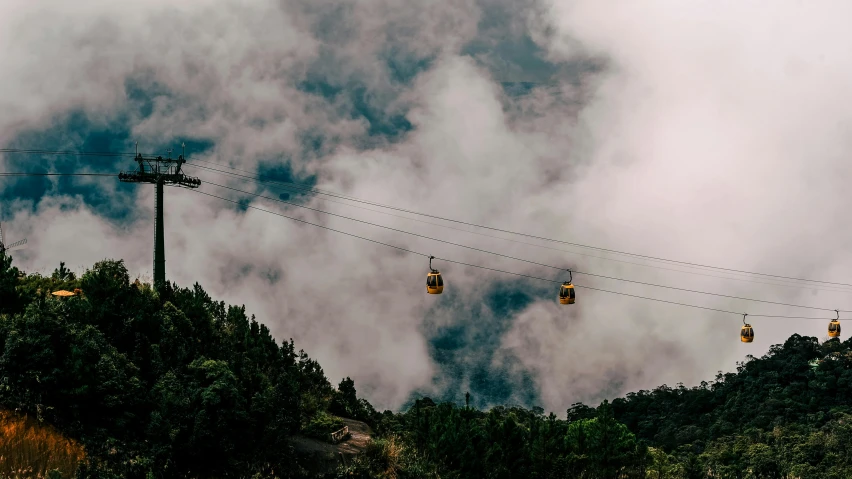 a group of gondolas sitting on top of a lush green hillside, pexels contest winner, realism, flying through the clouds, avatar image, tram, uttarakhand