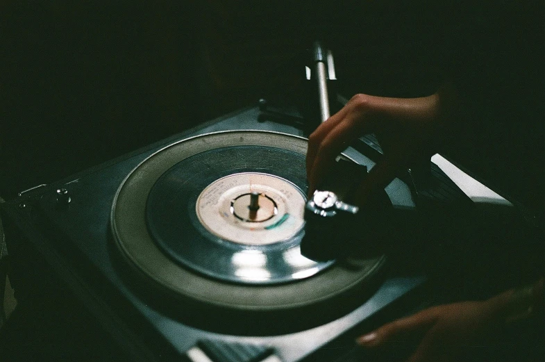 a close up of a person playing a record on a turntable, an album cover, inspired by Elsa Bleda, trending on pexels, instagram post, mid night, historical photo, smooth tiny details