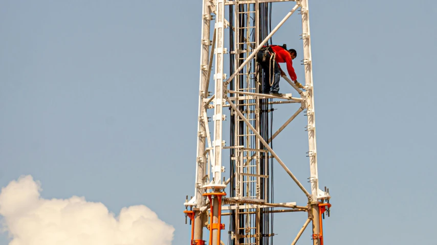 a man standing on top of a metal structure, repairing the other one, oil rig, profile image, brown