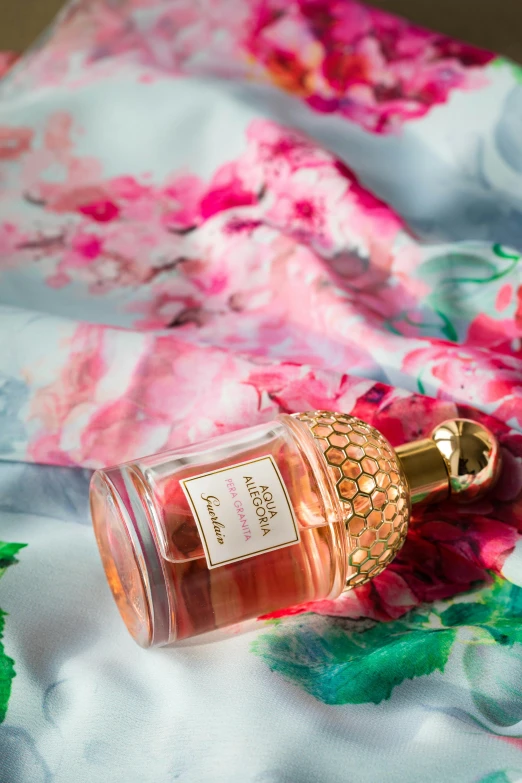 a bottle of perfume sitting on top of a bed, inspired by Alfred Edward Chalon, shutterstock contest winner, rococo, wearing pink floral chiton, studio product shot, honey, delicate patterned