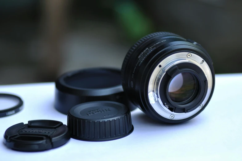 a camera lens sitting on top of a table, a macro photograph, by Niko Henrichon, sharp focus medium shot, short focal, nikkon