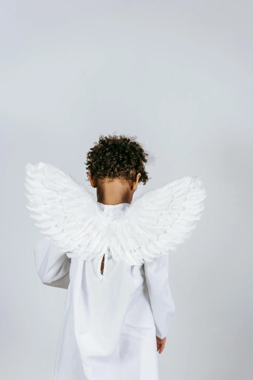 a little girl dressed up as an angel, an album cover, pexels contest winner, plain background, ashteroth, back - shot, 15081959 21121991 01012000 4k
