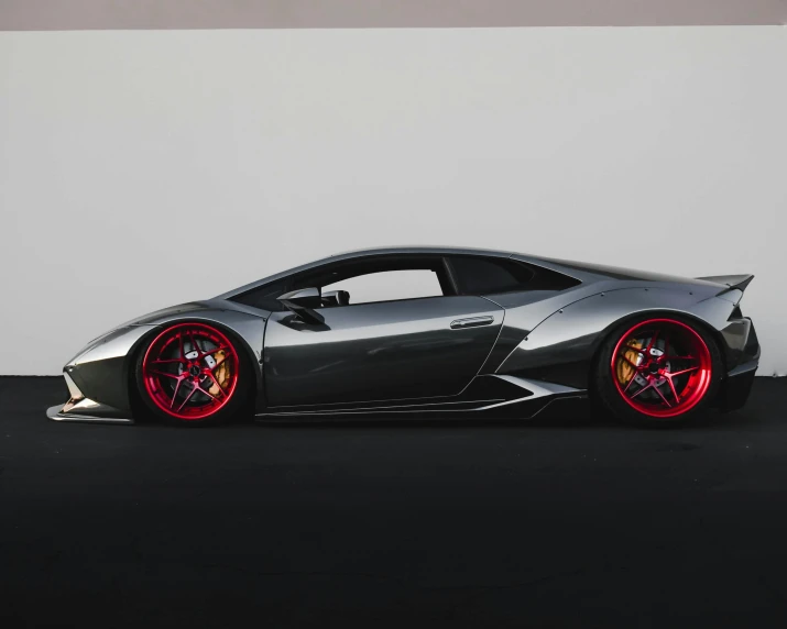 a silver and red sports car parked in a parking lot, by Sebastian Vrancx, pexels contest winner, bold lamborghini style, 2d side view, vantablack gi, on grey background