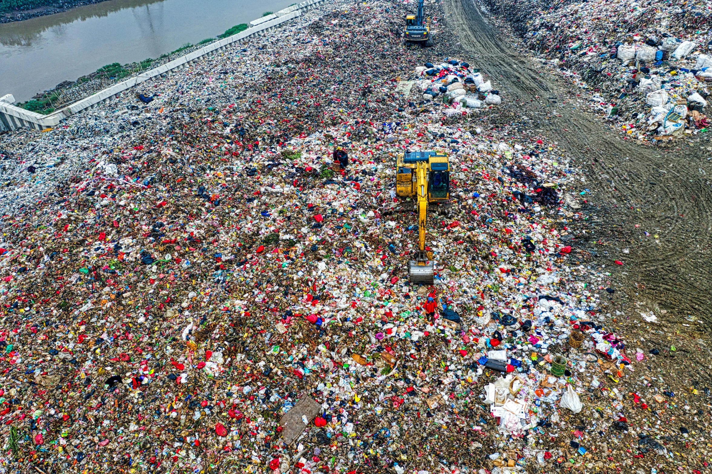 a large pile of garbage next to a river, reddit, drone photo, hou china, colorful”, 2 0 2 2 photo